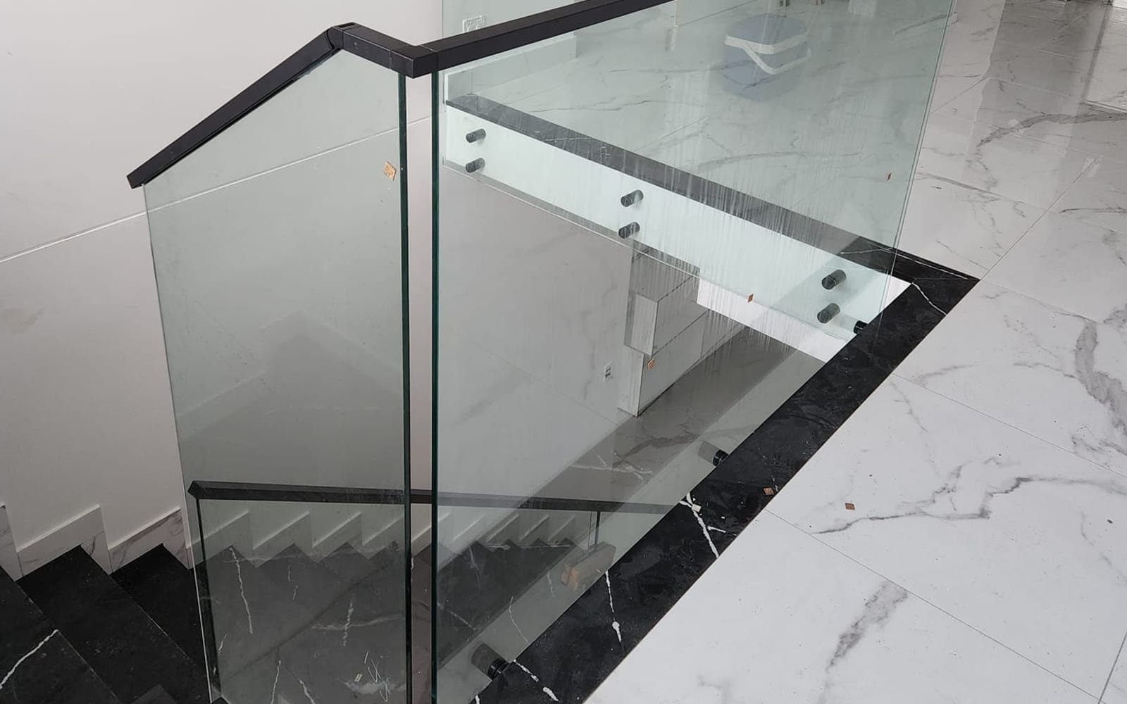 Glass balustrade installed on an external balcony overlooking a garden