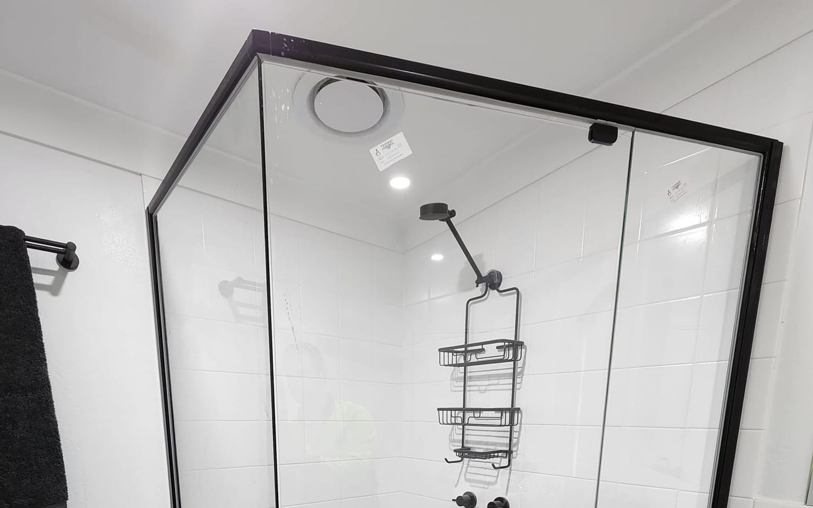 Frameless glass shower screen with polished hardware